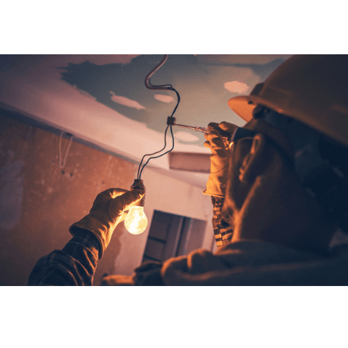 Electrician with Proper PPE Install Bulb and Socket